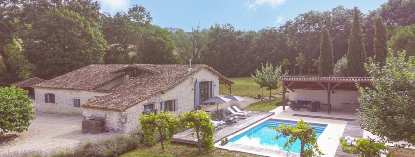 Beautiful farmhouse retreat set in french countryside. Aerial view of the converted barn and swimming pool and gardens.