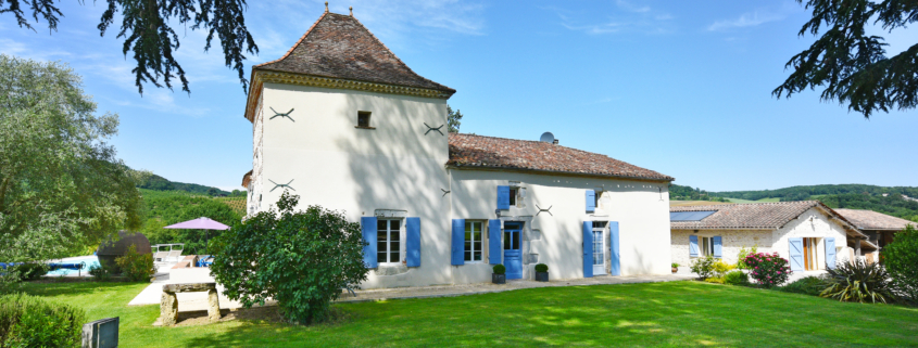 Manoir and Gite Holiday Rental view of White painted French Manoir with blue shutters and Pigionnier Tower