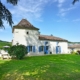 French Holiday Rental Manoir, painted white with blue shutters and pigionnier tower, set in lawned grounds