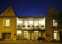 French stone house light at night.
